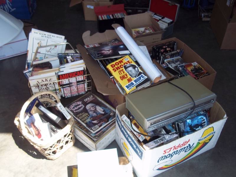 lot 38 image: VHSDVD  player with large selection of movies and a lot of books