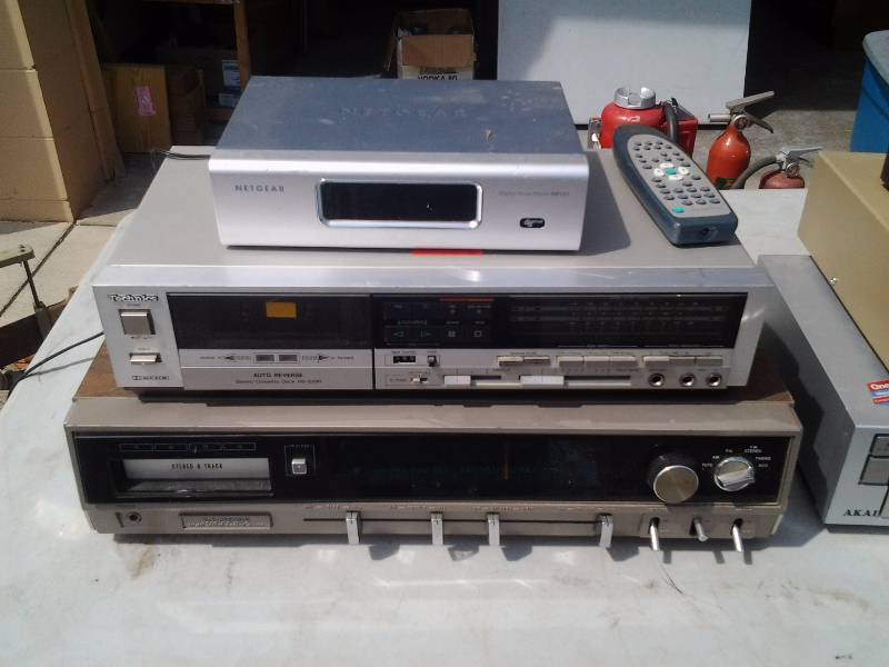 lot 83 image: Netgear Router, Technics Tape Player, Lloyds 8 Track Player Stereo With AMFM Tuner