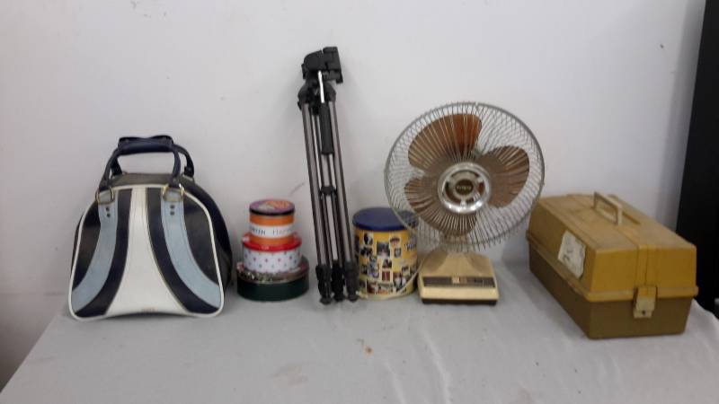 Bowling ball in bag, tins, tripod, fan, and tackle box