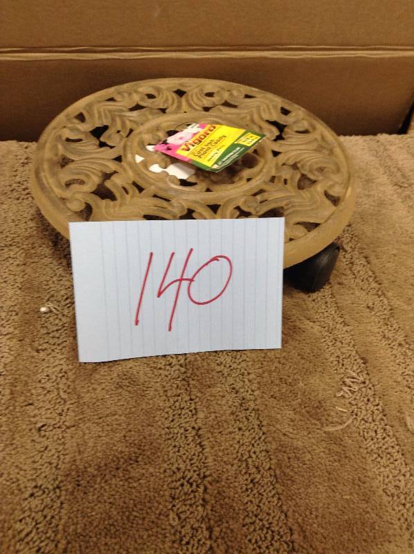 lot 140 image: 11.7 in. x 11.7 in. x 2.6 in. Brown Cast Iron Plant Caddy Model#  878758 New