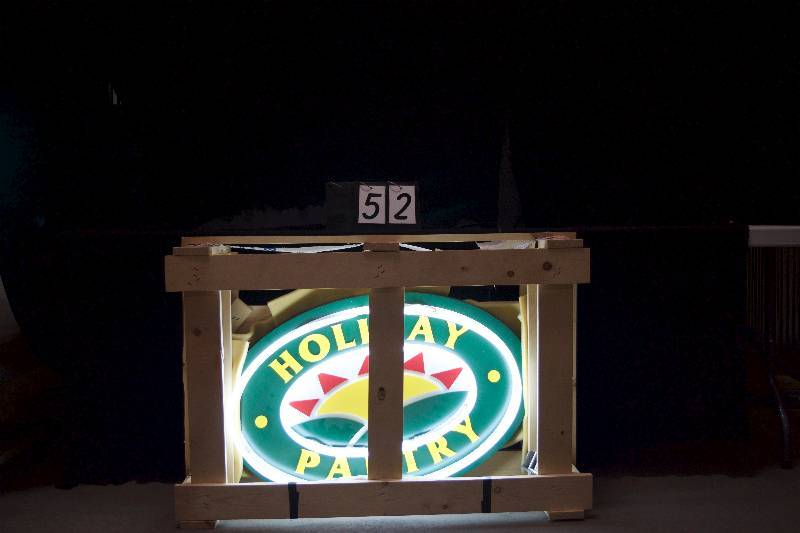 lot 52 image: Holiday Pantry neon sign , aluminum oval, new in crate, never installed, comes with mounting patterm.
