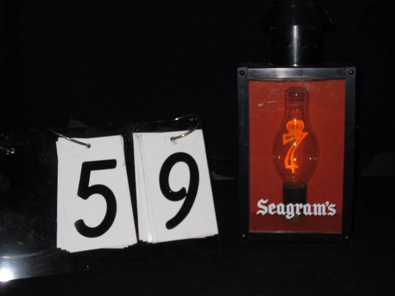 lot 59 image: Seagrams 7 plastic coach style light with 7 logo as lightbulb filament, unusual, and very cool