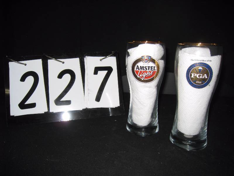 lot 227 image: Amstel PGA golf pilsner glasses, gold rim, both logos (Amstel and PGA) on each glass, very good condition
