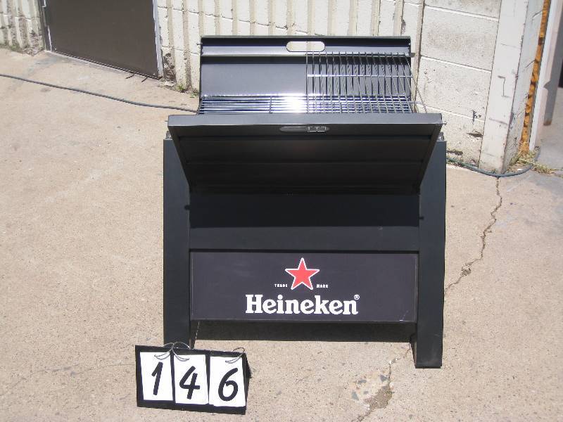 lot 146 image: Heineken portable 2 shelf grill, labelled for display only but looks like it could be used - has a grate for charcoal and heavy duty construction