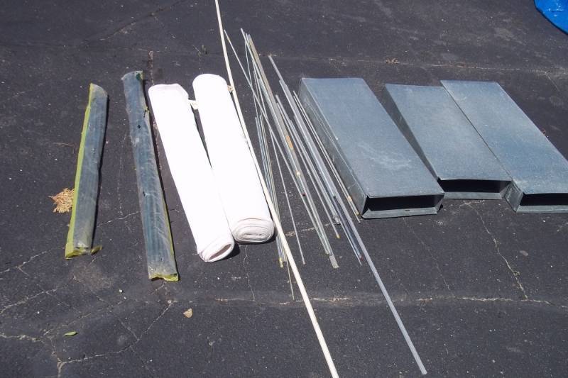Approx. 15 Sections of Ready Bolt of Assorted lengths and diameters, 3 Aluminum Sections, 2 Packages of Green Fiberglass Plant Stakes, 2 Rolls of Canvas Netting