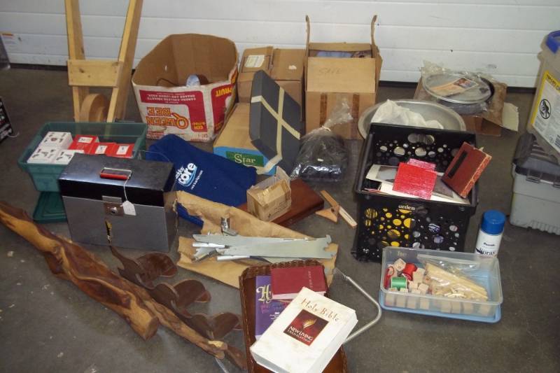 Dcor Plates, King James Bible, NLT Bible, Hymnal, Fry Pan, Hockey Puck, Pewter Collection, Assorted Books, Wooden Wheel Barrow Frame, Medium Box of Envelopes, Lamp