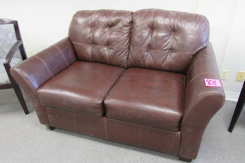 Simulated leather love seat.. Nice shape..