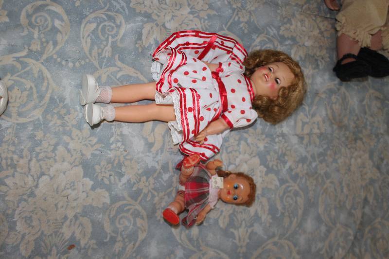 lot 21 image: Lot of (2) Dolls Includes Girl in White w Red Dot Dress, white Shoes, Girl w Plaid Dress, Red Shoes