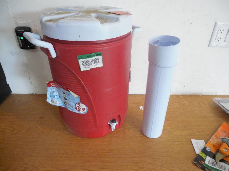lot 142 image: Rubbermaid 5 Gal. Modern Red Cooler with Cup Dispenser