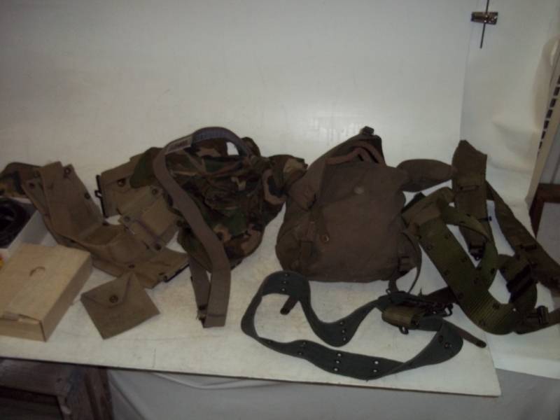 lot 67 image: Assorted Military Surplus items, Harness, Ammo Belts, Belts, Sack with Nylon and other Rope, Toiletry
