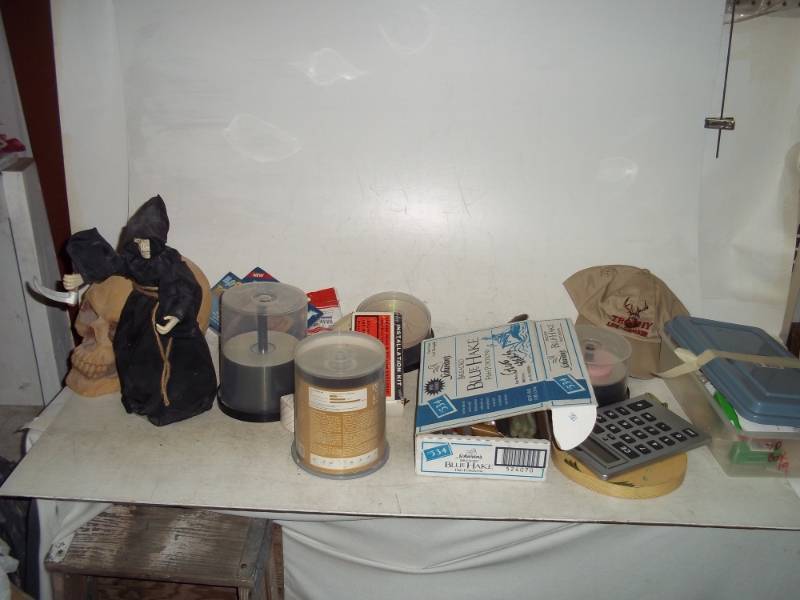 lot 77 image: Synthetic Skull, Grim Reaper, Lots of Soap, Adjustable Air Shock Line and Hardware, Blank CDs, Hot Glue Sticks, Sun Towel, Large Calculator
