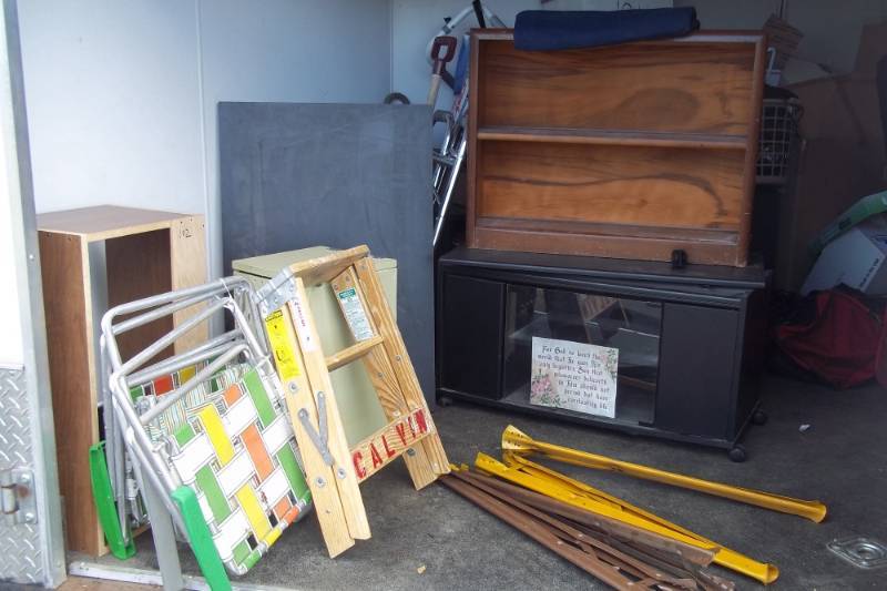 lot 102 image: Brown Wooden Shelf, Black Entertainment Center, Black Wood Sheet, 2 Foot Step Ladder, 4 Saw Horse Legs, Vintage Kids Lawn Chairs, Wooden Hamper