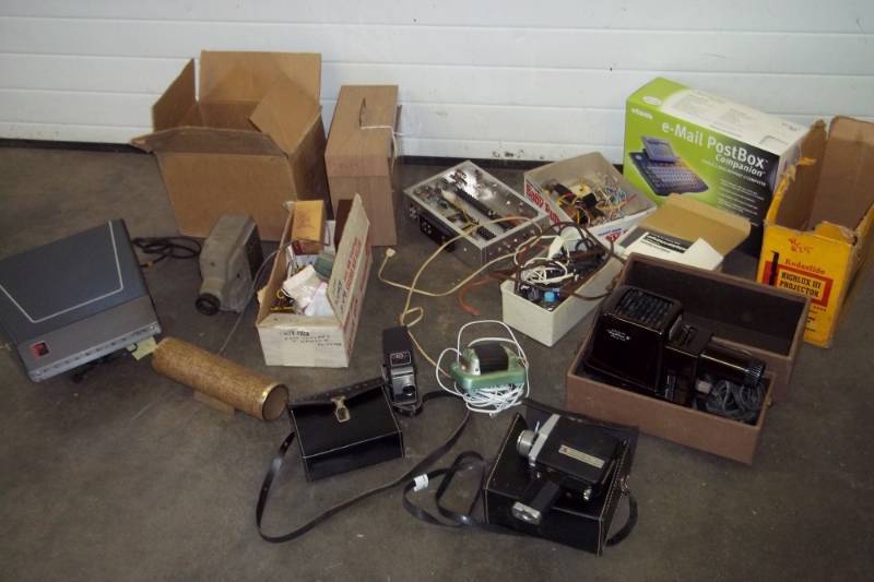 lot 103 image: Slide Projector, Air Cleaner Device, Vintage Cameras, Vintage Video Camera, Assorted Electrical Supplies, e-mail Post Box