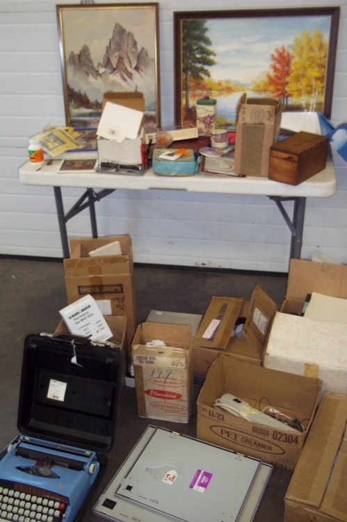 lot 109 image: Painting of Mountain, Painting of Lake, Vintage Typewriter, Childrens NIV Bible, Scissors, Flashlight, Candles, Assorted Dcor, Large Box of Printer Paper, 3 Packages of Carbon Copy Paper, Assorted Craft Supplies