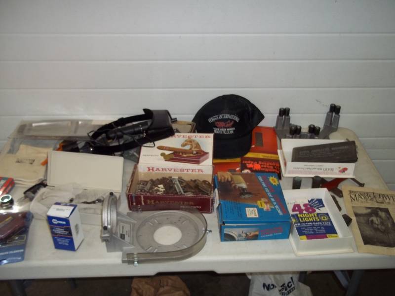 lot 129 image: WW2 Era Blister Gas Protector, NAPA Part, Fergus International Cap, Drill Bits, Corner Vices, 1925 Edition Mayflower Paper, Large Brass Military Cases, Magnets, Protective Cuff Gloves, Survival Knife