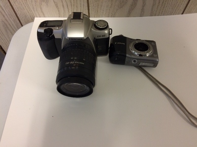 lot 24 image: Pentax ZX-30 & Canon Power Shot A1000 IS Cameras