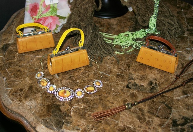 lot 56 image: Three Scarves, Necklaces and Lipstick Holders