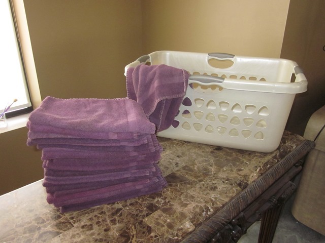 lot 177 image: 25 Purple Hand Towels and Laundry Basket