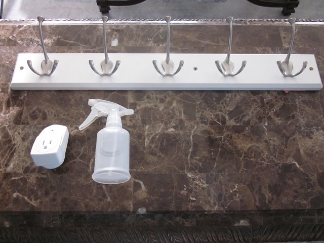 lot 200 image: Unit with 5 Hooks, Spray Bottle, and Light Sensor for Outlet