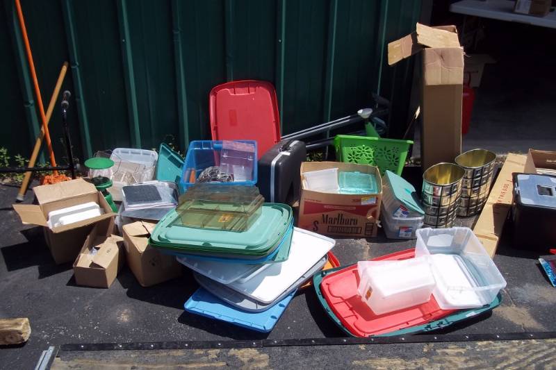 lot 210 image: 2 Garbage Cans, Typewriter, Cake Pans, Sterilite Filing Container, Assorted Plastic Containers and Tub Covers, Projector Screen, Watering Can
