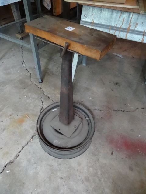 lot 31 image: Cast Iron Stand Mounted on Rim.