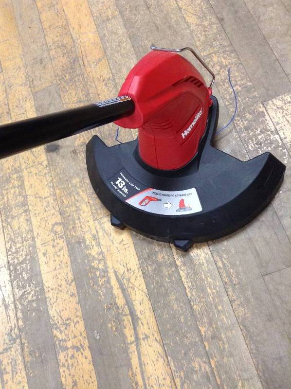 lot 53 image: Homelite 13 in. 4 Amp Straight Electric String Trimmer in working conditions