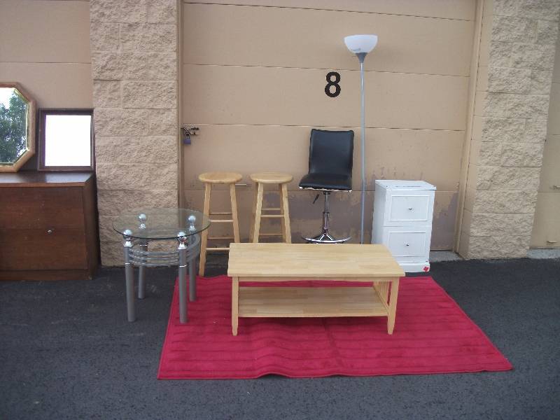 lot 22 image: 2-Wood Bar Stools, 1-Wood Coffee Table, 1-Swivel Adjustable Bar Stool, 1-Rug, 1-Glass Top End Table, 2 Drawer Cabinet, 1-Floor Lamp