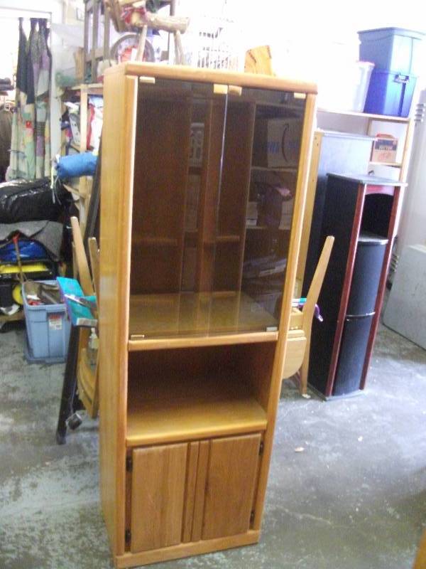 lot 27 image: Glass Door Media Storage Cabinet 24x17x72