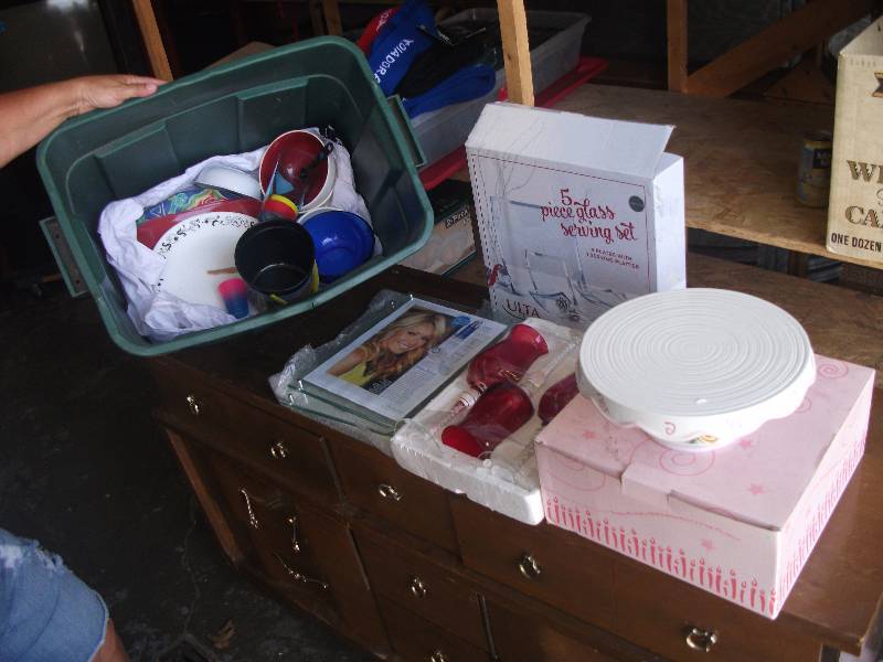 lot 30 image: Tote Bin & Contents-Red Glass Goblets Packaged, Pedestal Cake Stand In Box, 5-Piece Glass Serving Set In Box, Misc Dishes