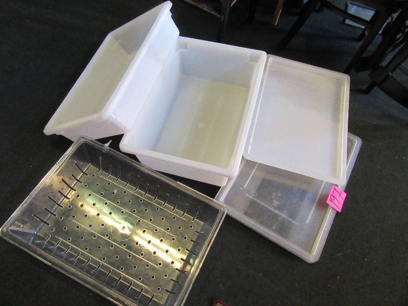 lot 197 image: 2 white plastic storage containers with covers.. Large perforated clear plastic container cover.
