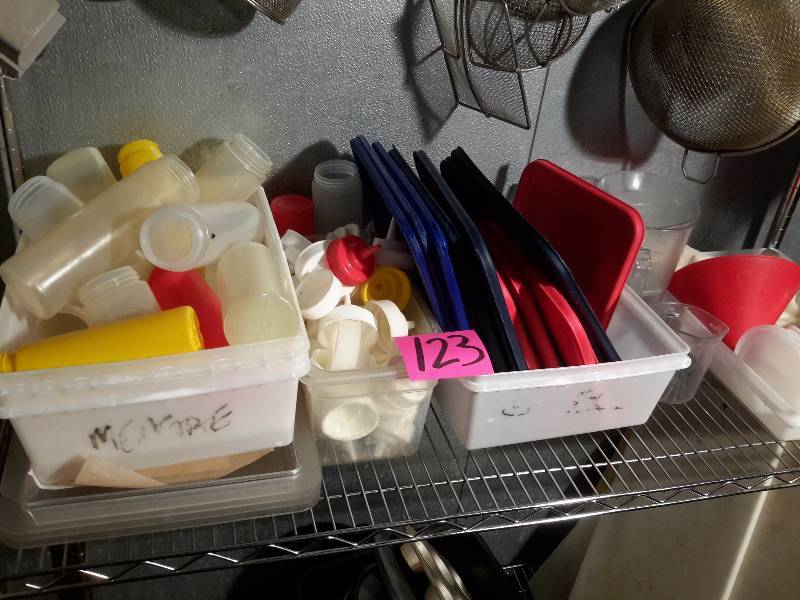 lot 123 image: Large lot of plastic covers and squeeze bottle containers and covers.. Other items as pictured