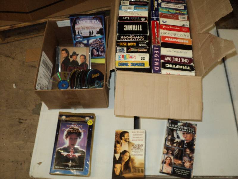 box of VHS tapes and DVDs and CDs...