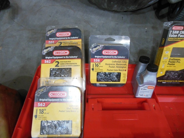 lot 233 image: Chain Saw Chains, Repair Items, and Small Fuel Container