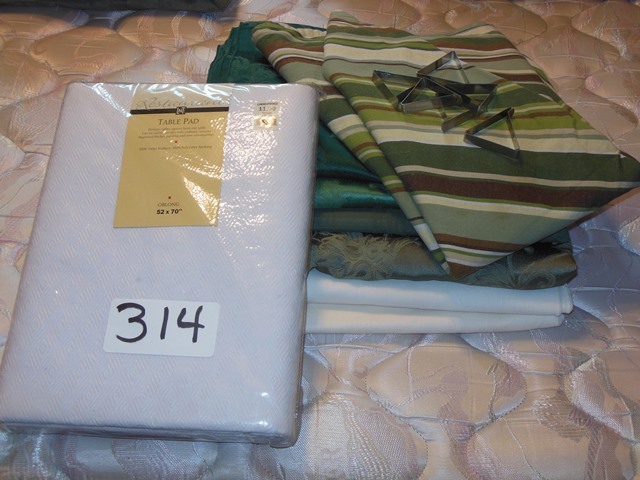 lot 314 image: Table Cloths, New Oblong Table Protector (52 x 70)  Pad and Tablecloth Hold-downs