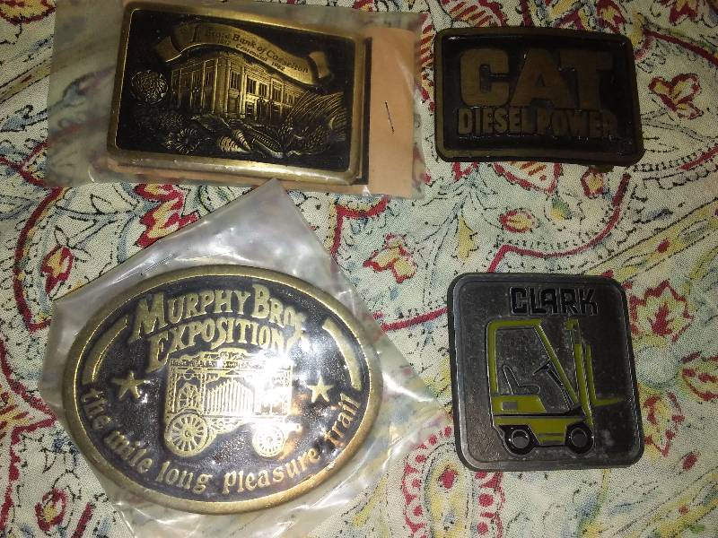 lot 9 image: Assorted Belt Buckles (4) Clark, Cat, Murphy Bros.