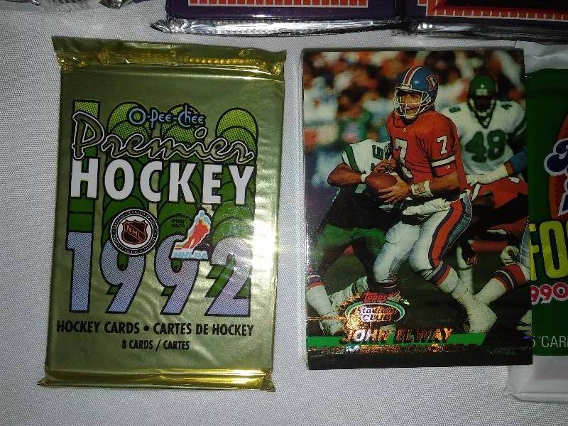 lot 15 image: Baseball Football Hockey Cards (13 pkg.) New in package