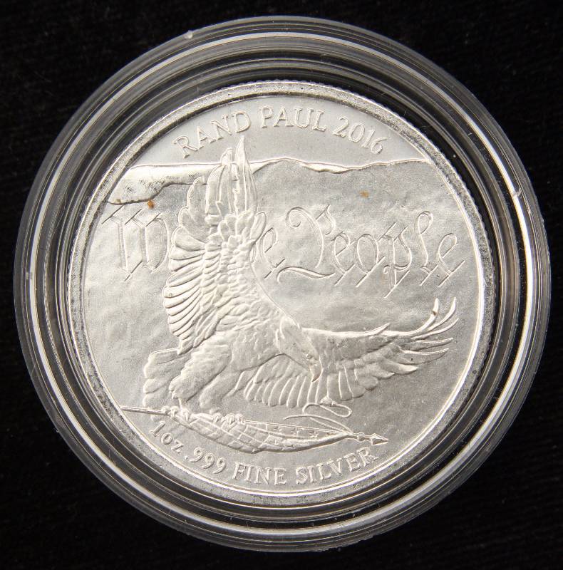 lot 40 image: 1 TROY OZ. .999 FINE SILVER RAND PAUL ROUND IN AIRTITE HOLDER