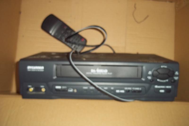 lot 83 image: VHS player with books and vintage Popular Mechanics magazines