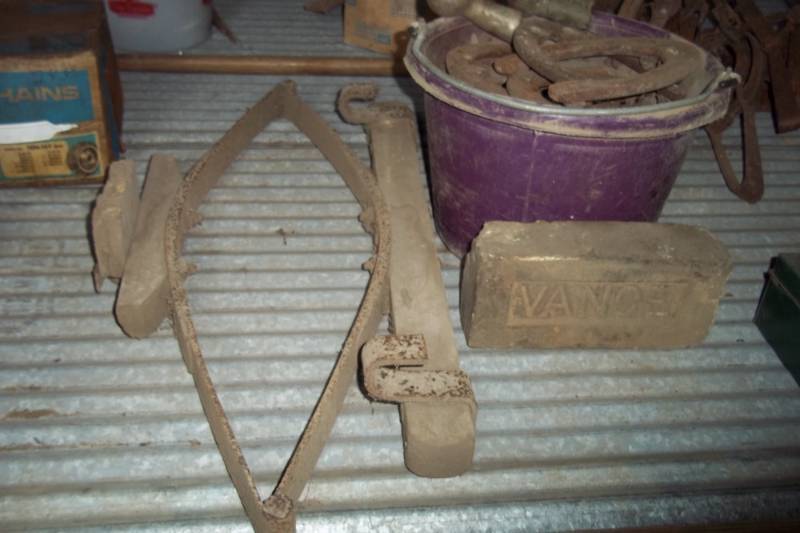 lot 154 image: Pail of horse shoes - buggy seat spring