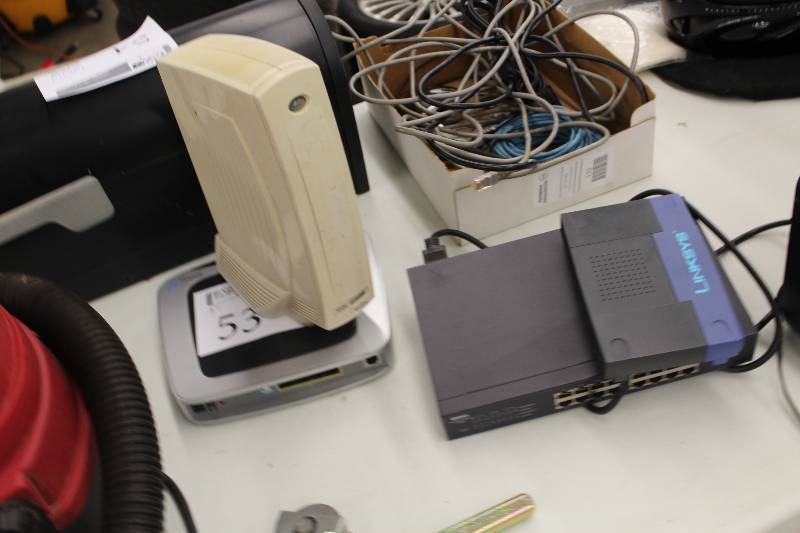 lot 53 image: Lot of (4) Electronics Includes Linksys Wireless Router, Dell Power Connect 2216 Modem, Wyse Winterm, And More