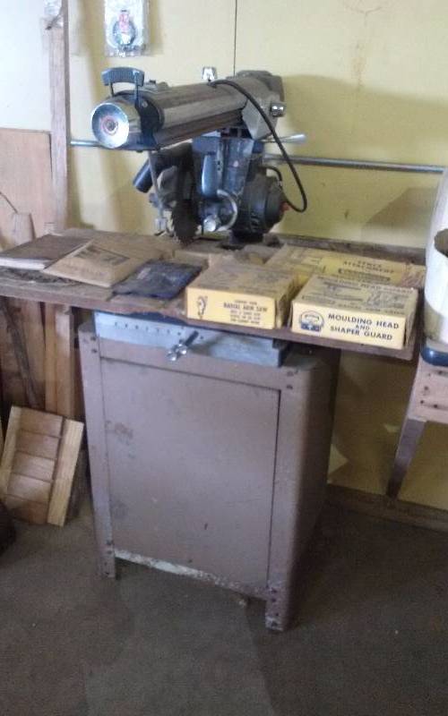 lot 20 image: Craftsman Radial Arm Saw on Table, with Misc Attachments, Shapers, Blades & Books.