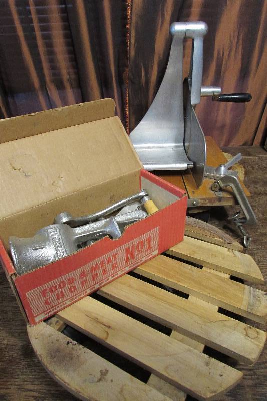 lot 599 image: TWO PLANT BASES ON WHEELS, ANTIQUE MEAT SLICER AND MEAT GRINDER
