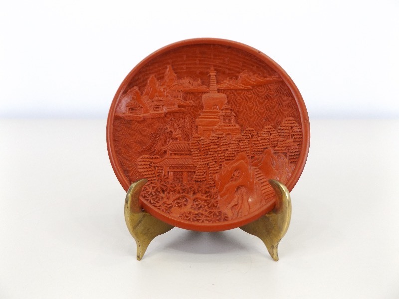 lot 19 image: Vintage Small Cinnabar Lacquered Plate with Heavy Brass Stand