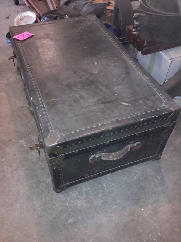 lot 51 image: Hardboard with metal Trim trunk.. Main latch broken but overall good shape.