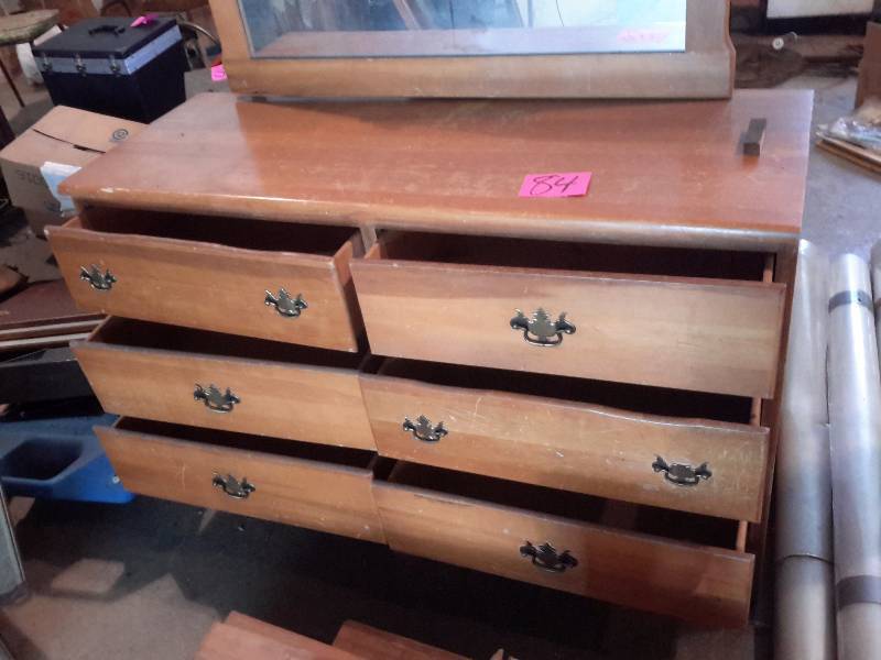 lot 84 image: 6 drawer PINE dresser with Mirror. One drawer looks to have some damage on the top front.  Not sure what that is from.