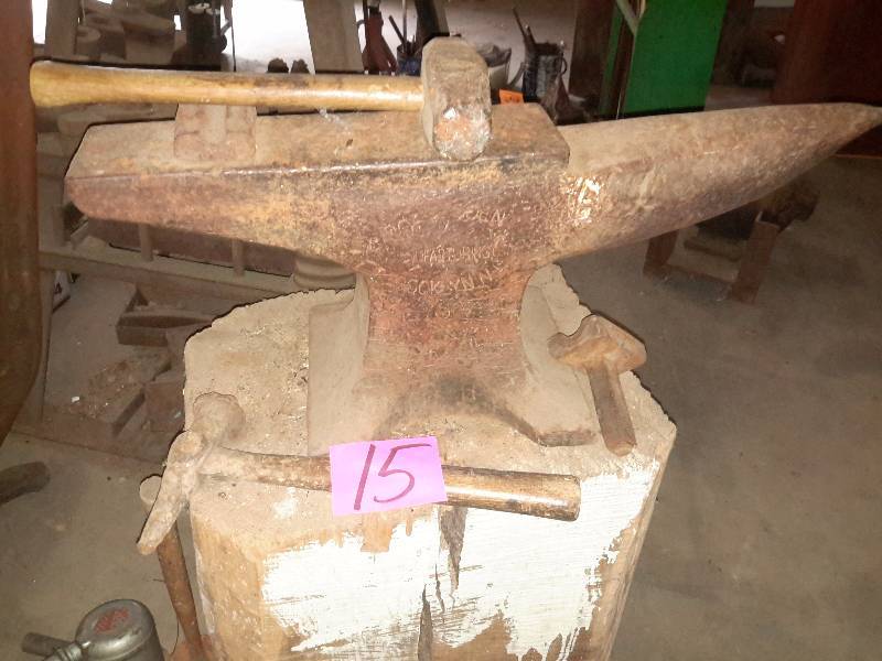 lot 15 image: Antique ANVIL.. Not sure of the writing on it.. Includes 2 hammers and the block it sits on.