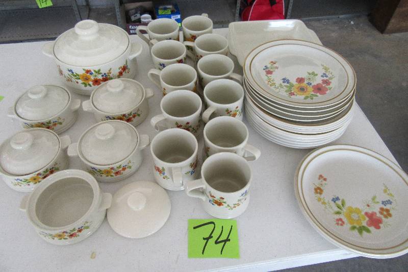 lot 74 image: Bake Serve n Store Glassware 11 Plates plus 1 with chip 11 mugs, Casserole with cover 5 small casseroles with covers (1 cover not the same as the rest), 1 ServingBaking Dish
