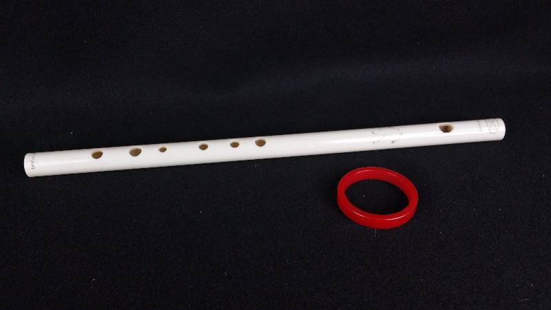 lot 73 image: Bakelite () Toy Flute & Red Bracelet
