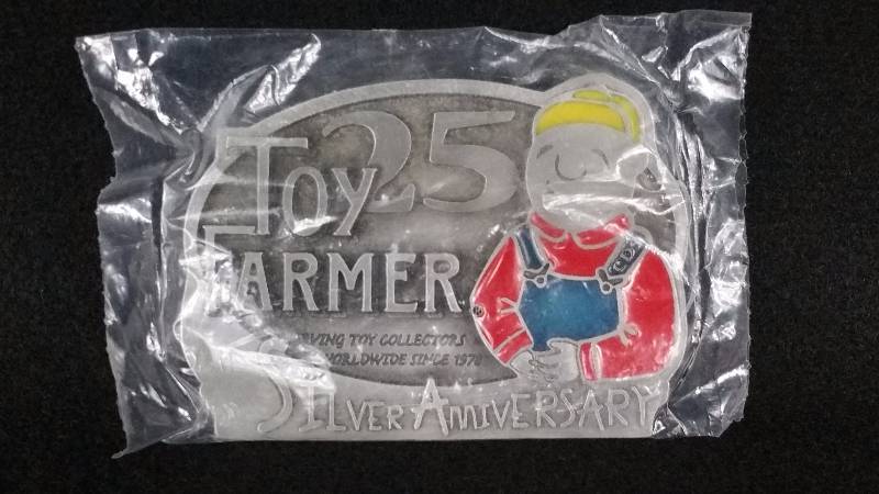 lot 74 image: Toy Farmer 25th Silver Anniversary Belt Buckle in Packaging