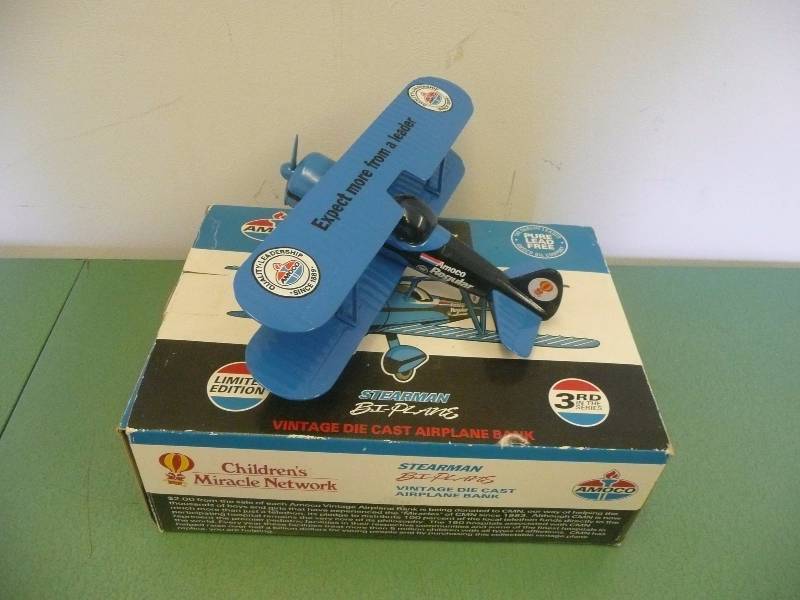 lot 27 image: AMOCO REGULAR LEAD FREE STEARMAN BI-PLANE - VINTAGE DIE CAST AIRPLANE BANK - LIMITED EDITION - SPEC CAST 1993